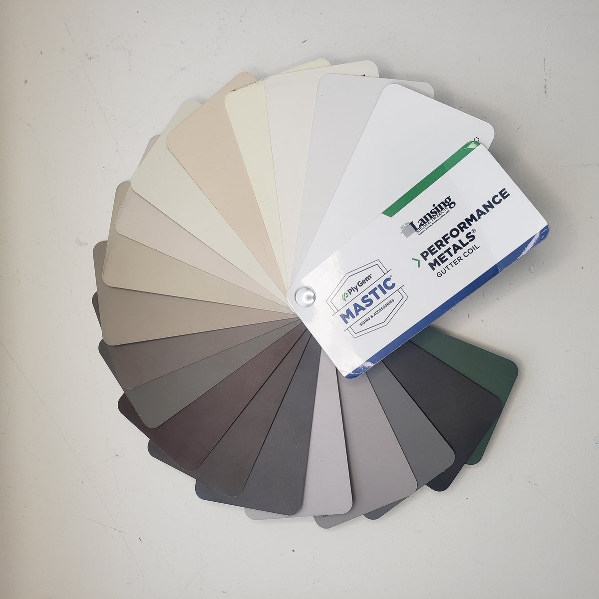 Color-matched channel swatches held against trim at an onsite quote visit