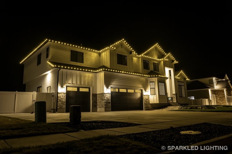 Christmas lights installed on a 2 story house on a Kaysville Utah home in warm white