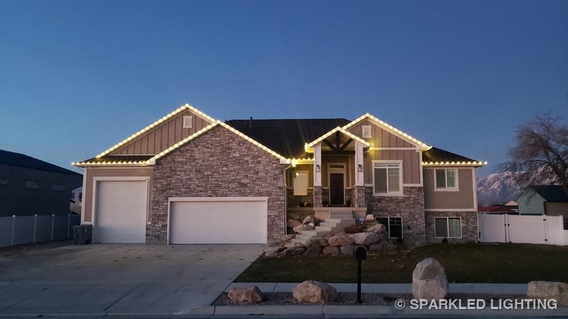 Christmas lights installed on a single story house on a Ogden Utah home in warm white