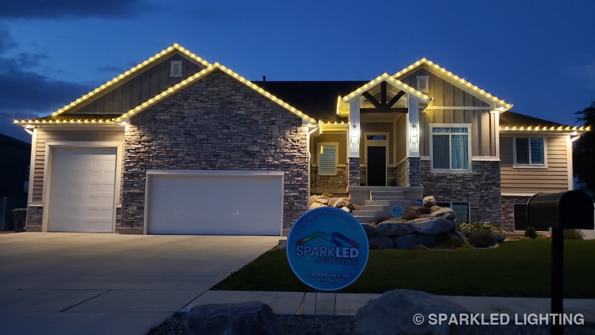 Seasonal Christmas lights on a single story Ogden Utah home in warm white