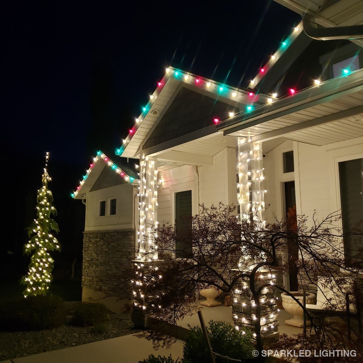 Christmas lights on a Pleasant View Utah front porch, columns and tree in red, green and white