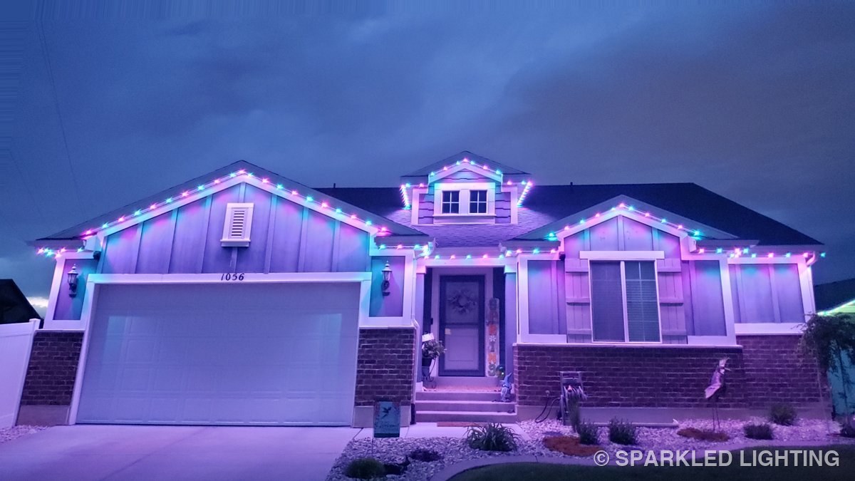 The same Clearfield Utah home lit in purple permanent LED lights