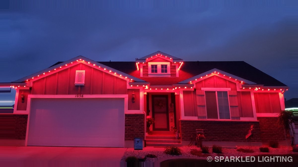 The same Clearfield Utah home lit in red permanent LED lights