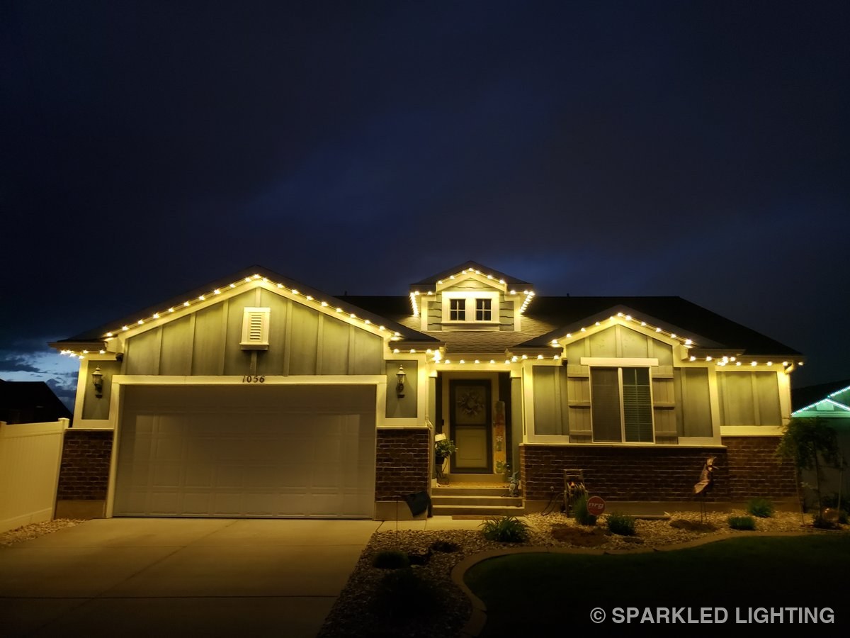 The same Clearfield Utah home lit in warm white