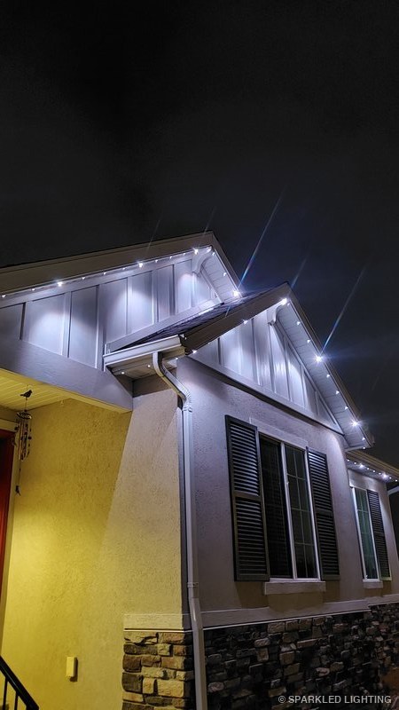 Permanent LED lights installed on gable close-up on a Clinton Utah home in white