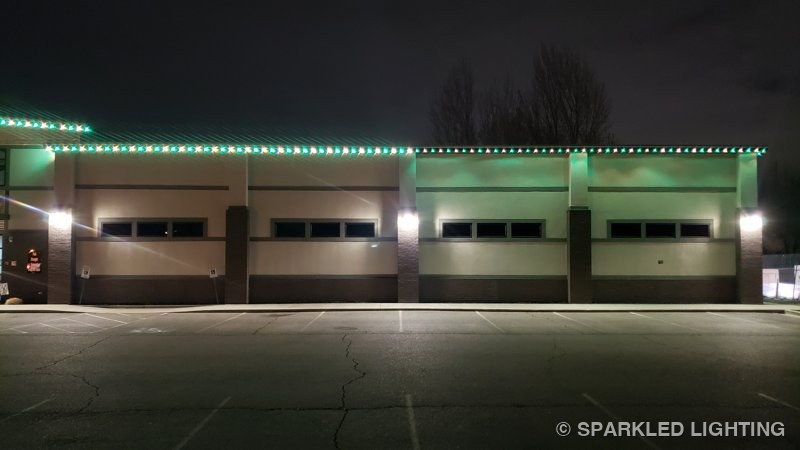 Out-aimed permanent LED lights tracing a crisp green outline on Shaw Dance Studio in Clinton Utah