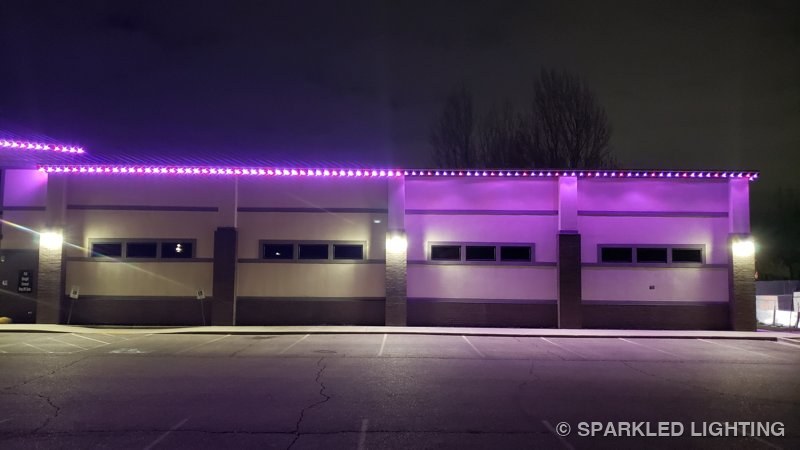 Down-aimed permanent LED lights washing the walls of Shaw Dance Studio in Clinton Utah in purple