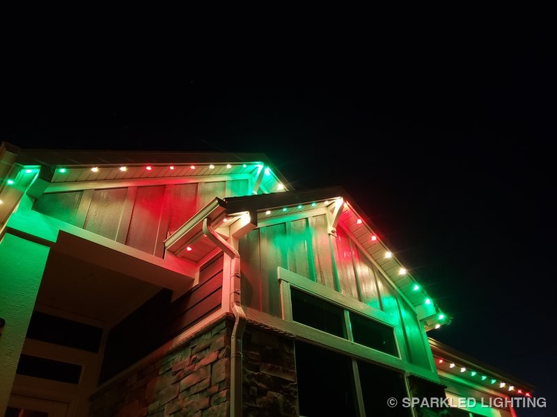 Permanent LED lights installed on gable close-up on a Farr West Utah home in red and green