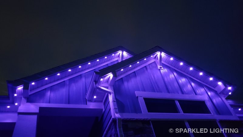 Permanent LED lights installed on gable close-up on a Farr West Utah home in purple