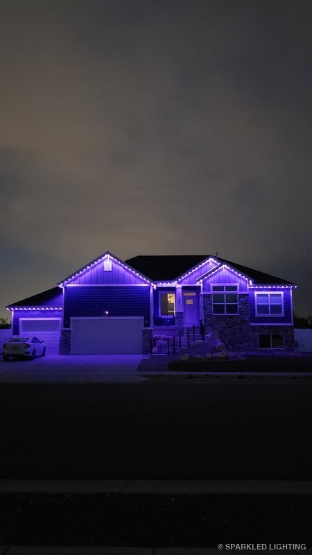 Permanent LED lights installed on a single story house on a Farr West Utah home in purple