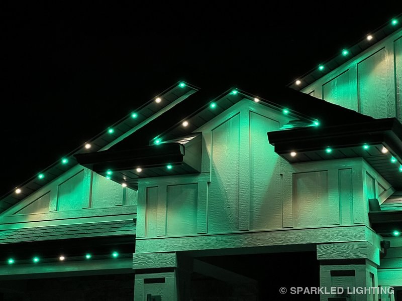 Permanent LED lights installed on peak close-up on a Hooper Utah home in green