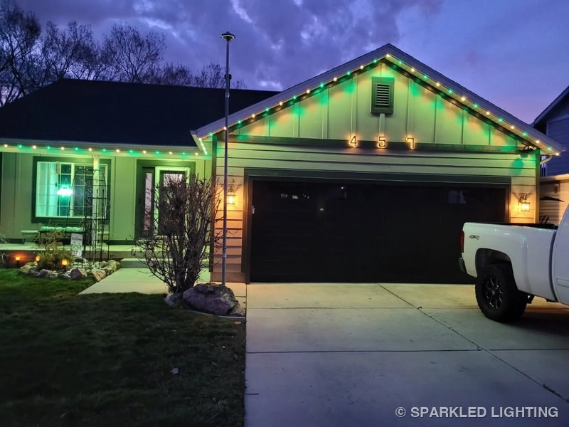 Permanent LED lights installed on a single story house on a Ogden Utah home in green and warm white