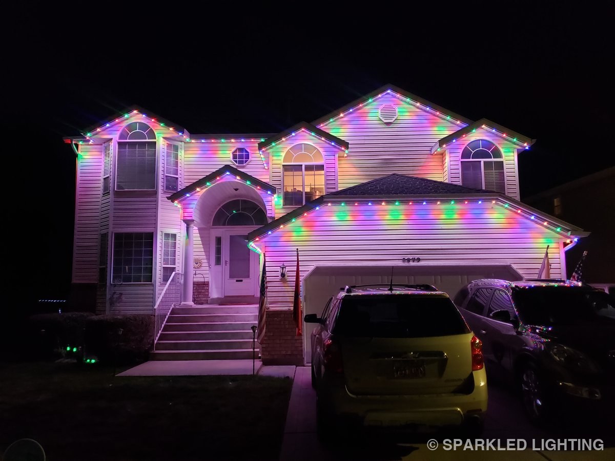Permanent LED lights in multicolor on a 2 story Roy Utah home