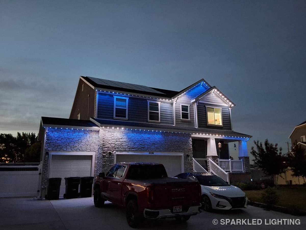 Permanent LED lights installed on a 2 story house on a Syracuse Utah home in white and blue