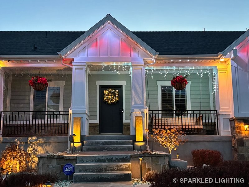 Permanent LED lights installed on front porch close-up on a Syracuse Utah home in white and pink