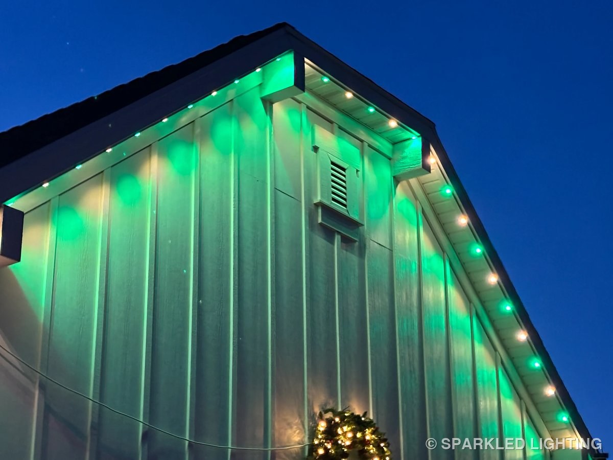 Close-up of permanent LED lights on a Syracuse Utah gable in green and warm white