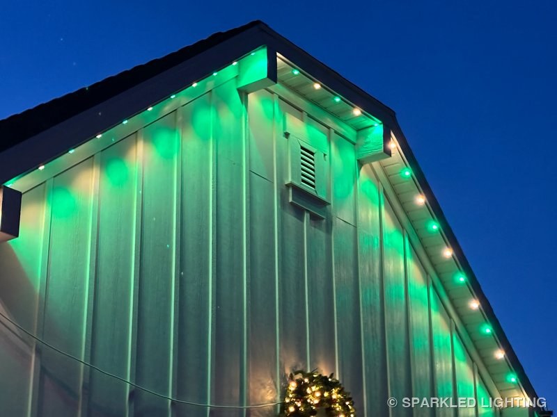 Permanent LED lights installed on gable close-up on a Syracuse Utah home in green and warm white