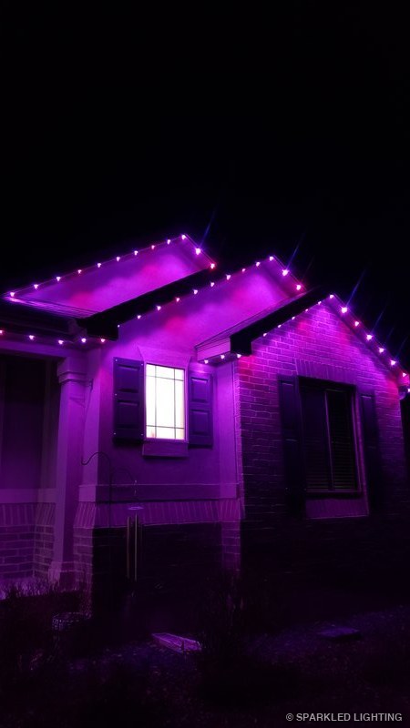 Permanent LED lights installed on gable close-up on a Syracuse Utah home in pink