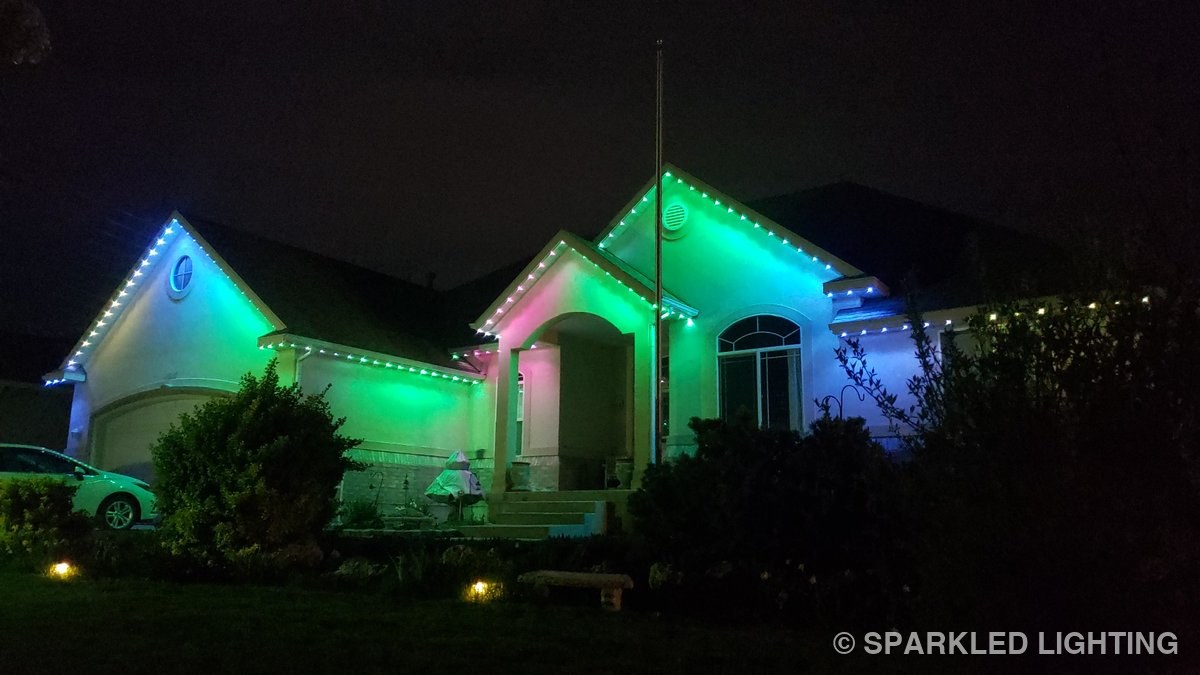 Permanent LED lights on a single story Syracuse Utah home in green, blue and pink