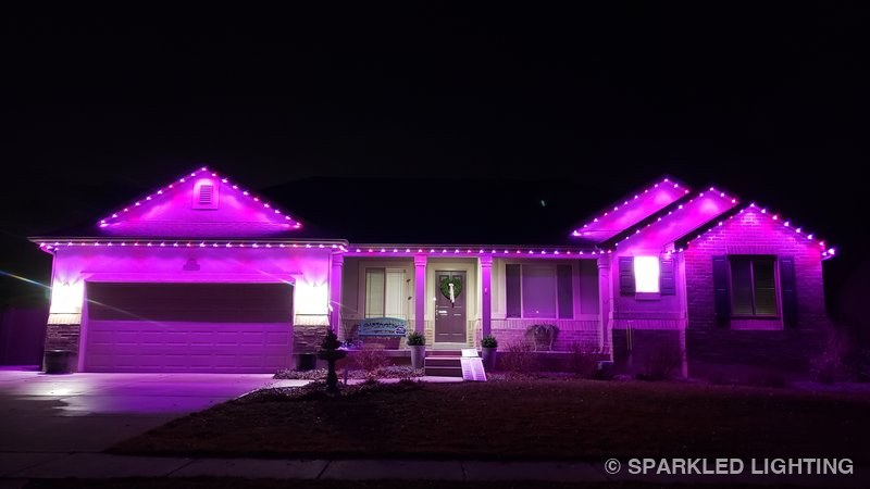 Permanent LED lights installed on a single story house on a Syracuse Utah home in pink