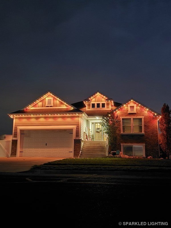 Permanent LED lights installed on a single story house on a Syracuse Utah home in red, orange and yellow