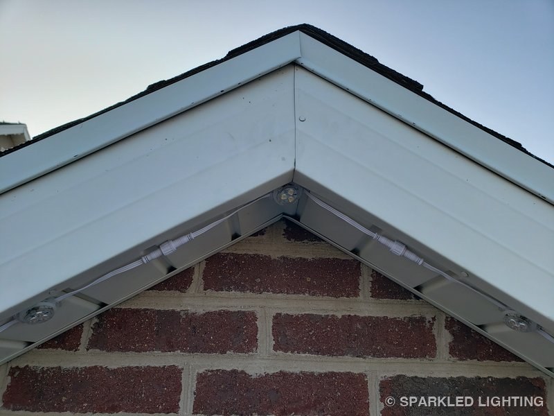 Removable RGBW lights installed on peak close-up on a Utah home