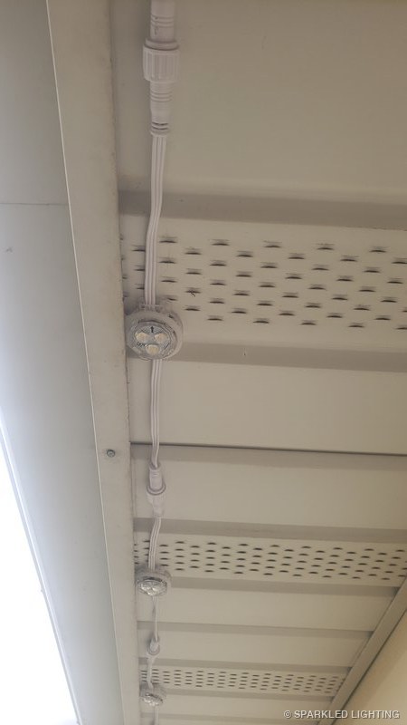 Removable RGBW lights installed on soffit close-up on a Utah home
