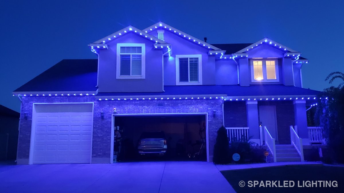 The same Layton Utah two story home at night glowing solid blue with SmartClip LED lights