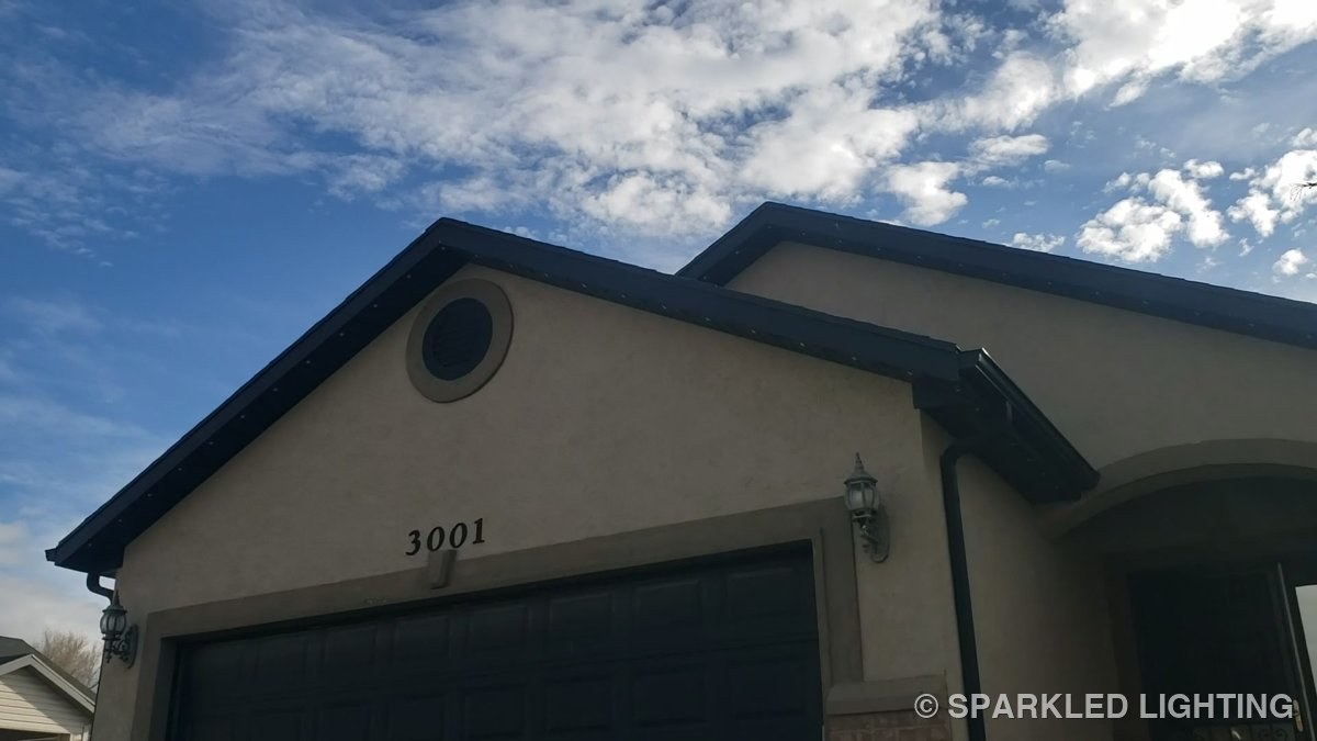 A Roy Utah home by day with SmartClip LED lights along the dark roofline, visible only as small white dots