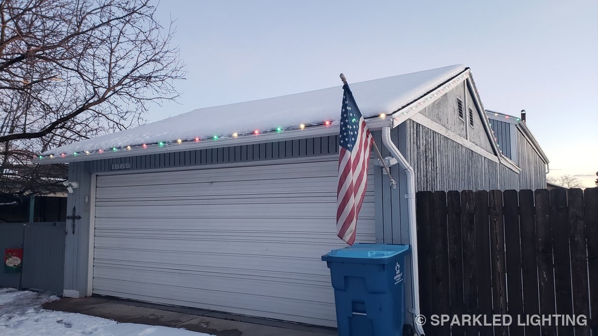 SmartClip LED bulbs visible by day along a snowy Ogden Utah roofline