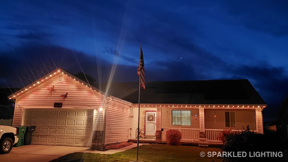 SmartClip LED lights glowing warm white over the porch of a Roy Utah home